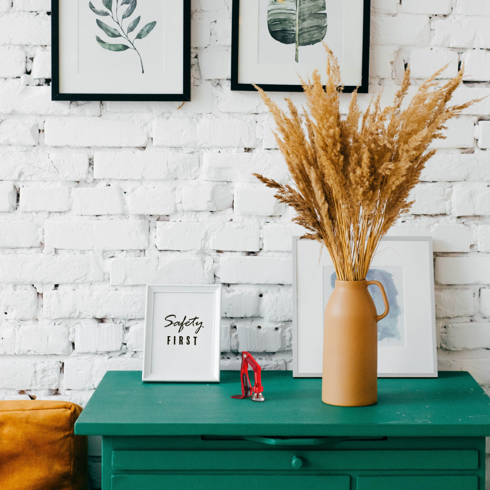 white brick will with red DoorJammer on green drawers with a small sign that says Safety First